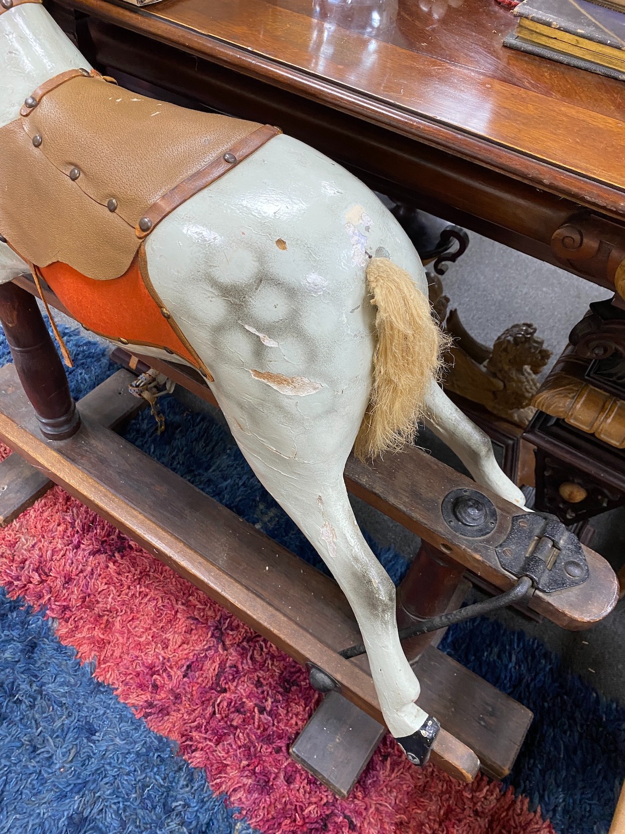 An early 20th century carved wood dapple grey rocking horse on safety frame, height 95cm